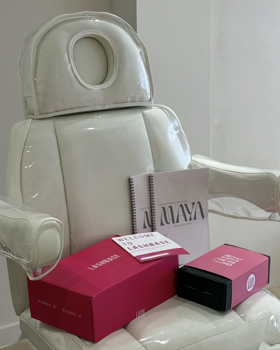 A Maya Academy treatment chair with training manuals and student lash kits laid out on it