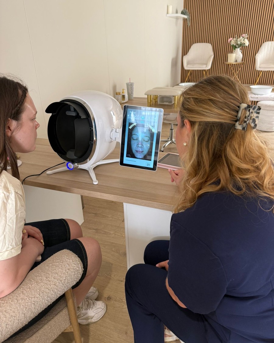 Rachel reviewing a client's skin analysis on the skin analyser