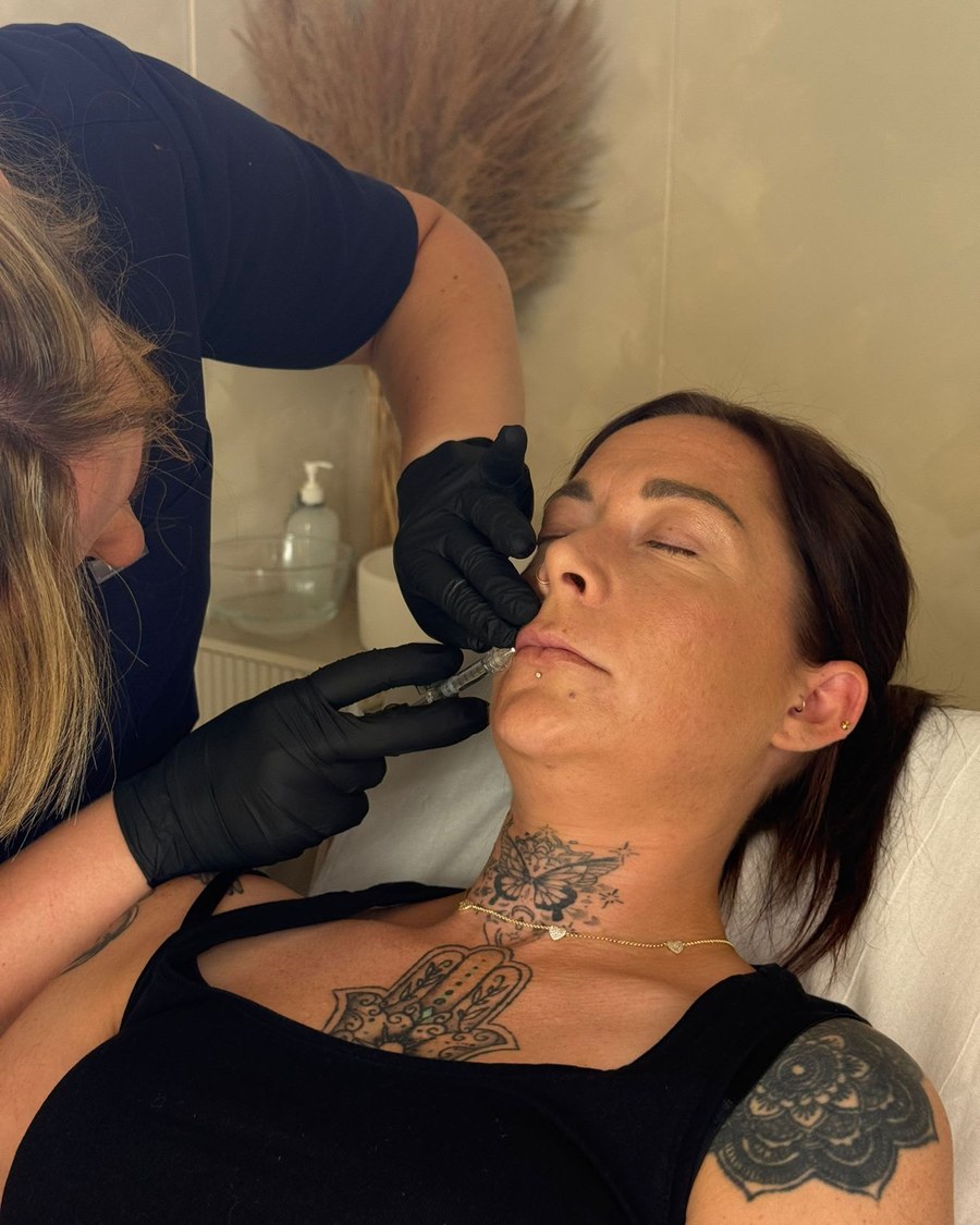 Rachel carrying out a precise facial injection treatment