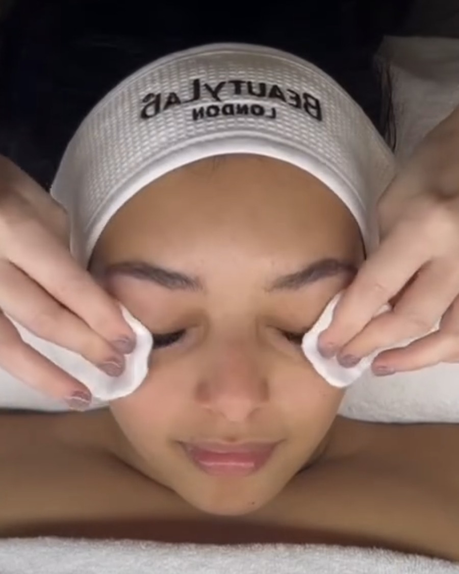 Client having her eye area gently cleansed with cotton pads during a BeautyLab facial