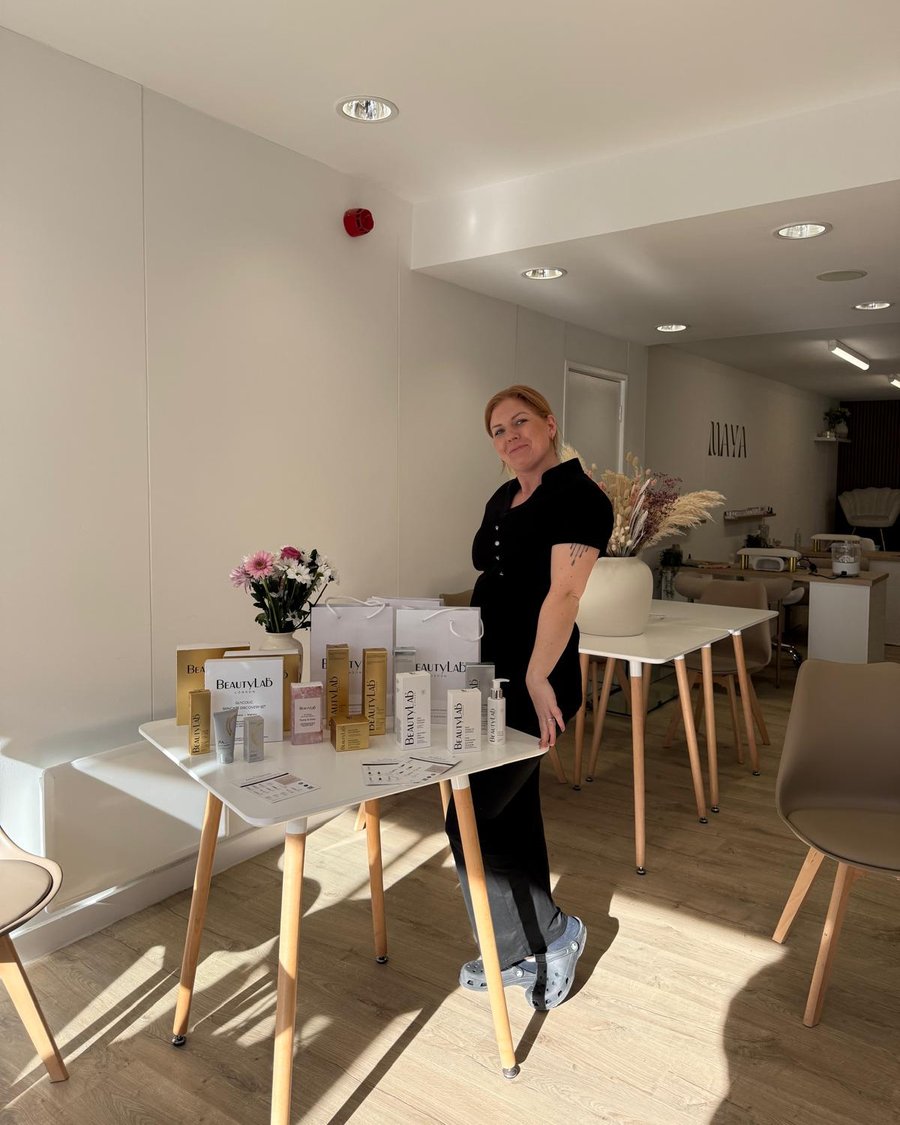 Sam beside the BeautyLab product display in the Maya salon