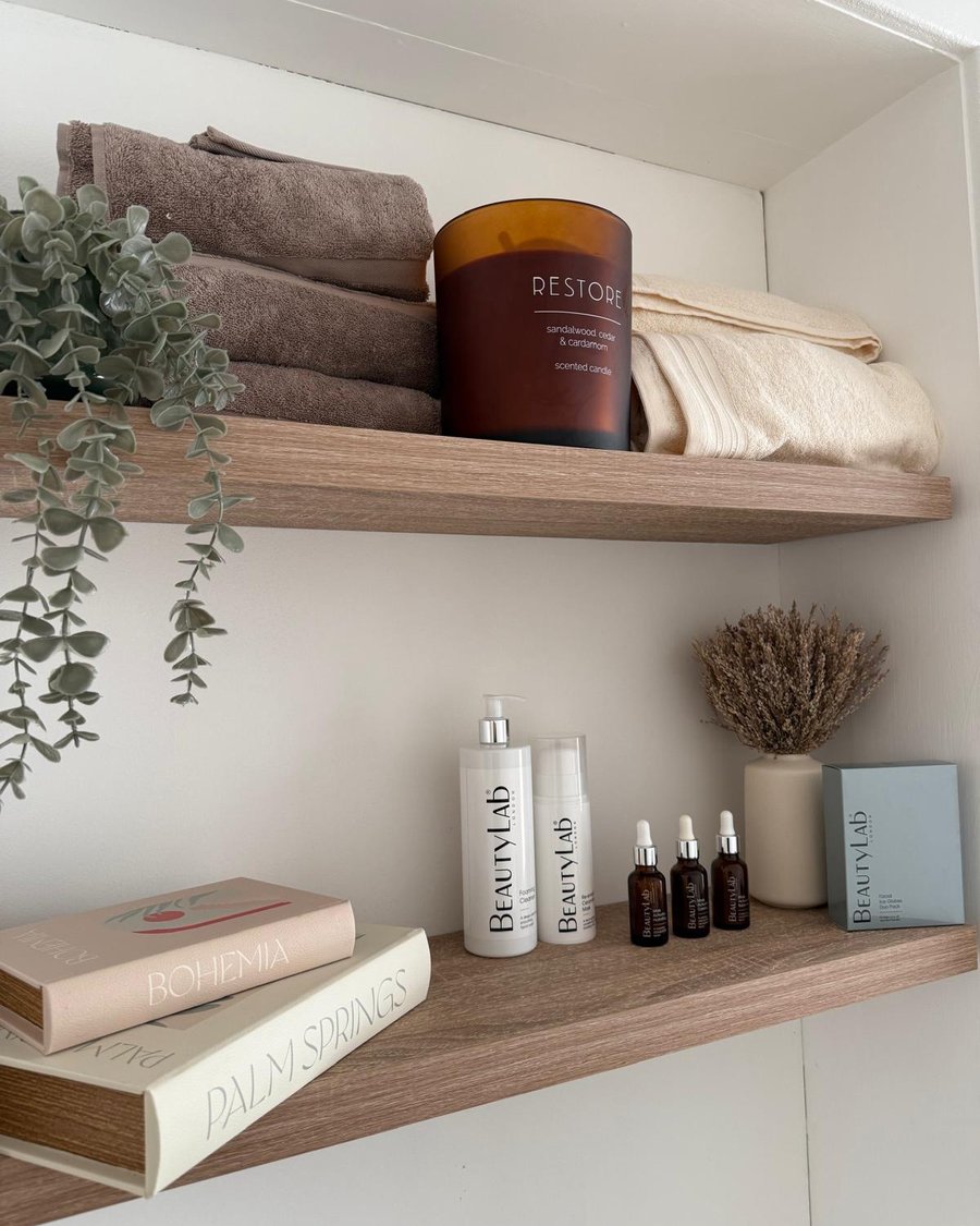 Shelves in the Maya treatment room with BeautyLab skincare, towels and a scented candle