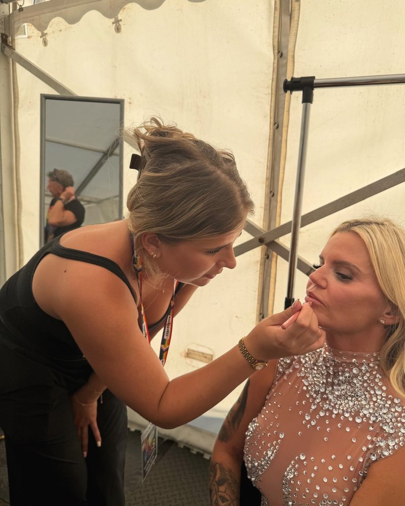 Maya makeup artist applying lip liner to a client backstage at a live event