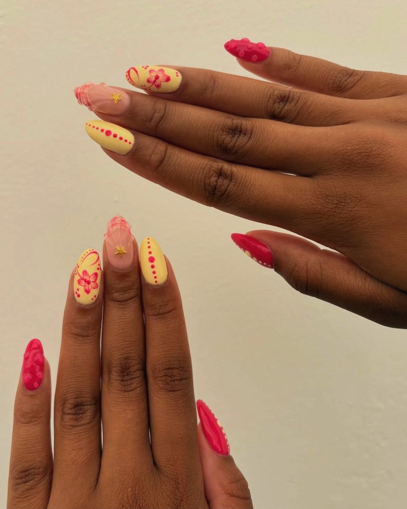 Yellow and pink floral nail art with a gold star charm