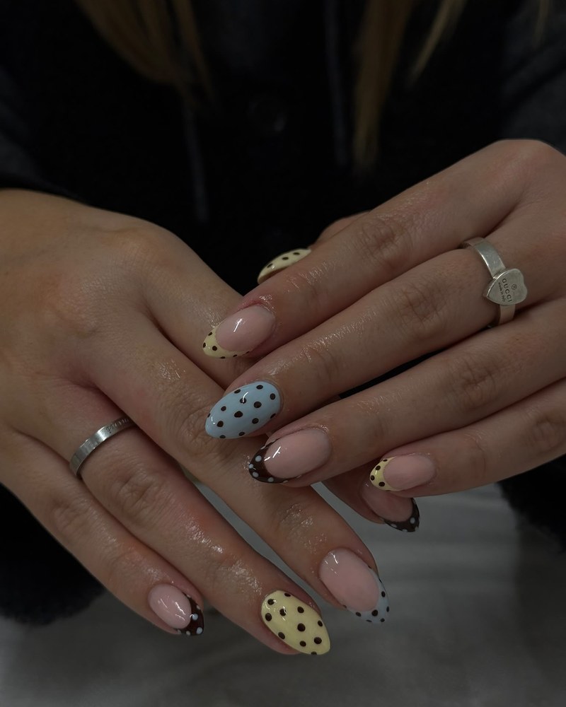 Nail art with hand-painted polka dots in cream, blue and chocolate brown