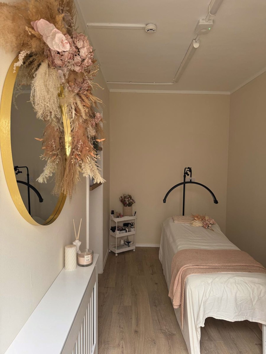 Maya treatment room with gold mirror, dried floral installation and treatment bed