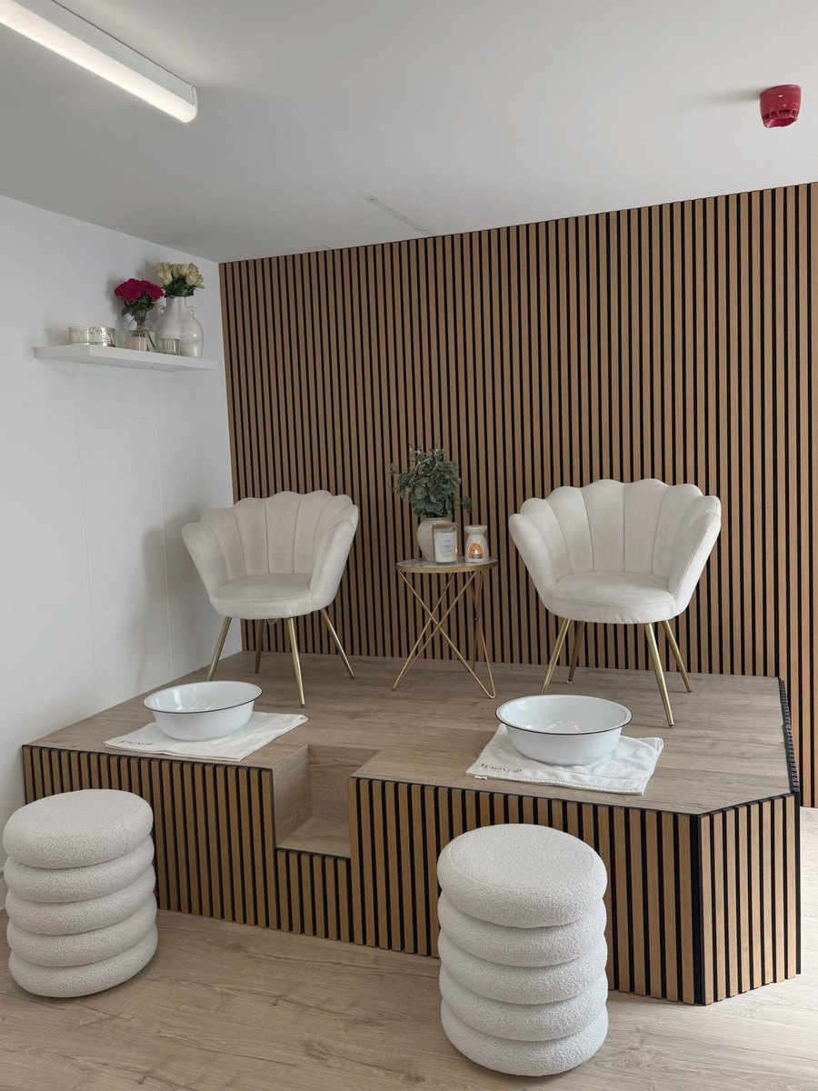 Maya pedicure station with shell chairs and oak slat wall