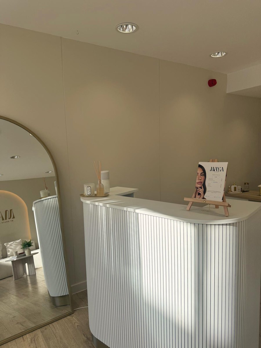 Maya reception desk with fluted front, arched mirror and menu card